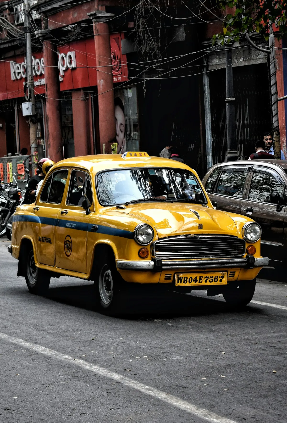 Classic yellow taxi cab on the streets of Kolkata, India